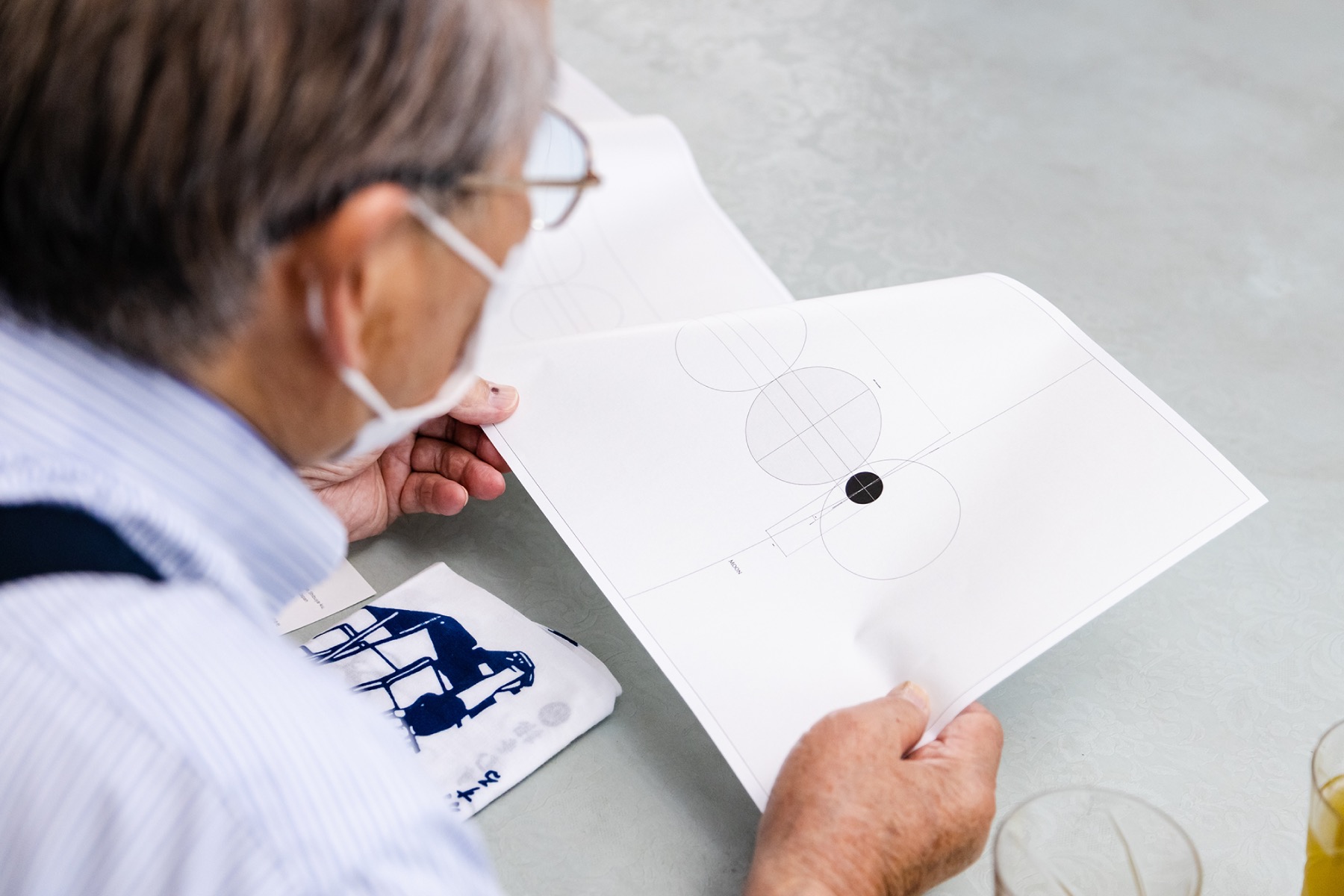 Mr. Fukuda, the chairman, watching enthusiastically with a sample in his hand