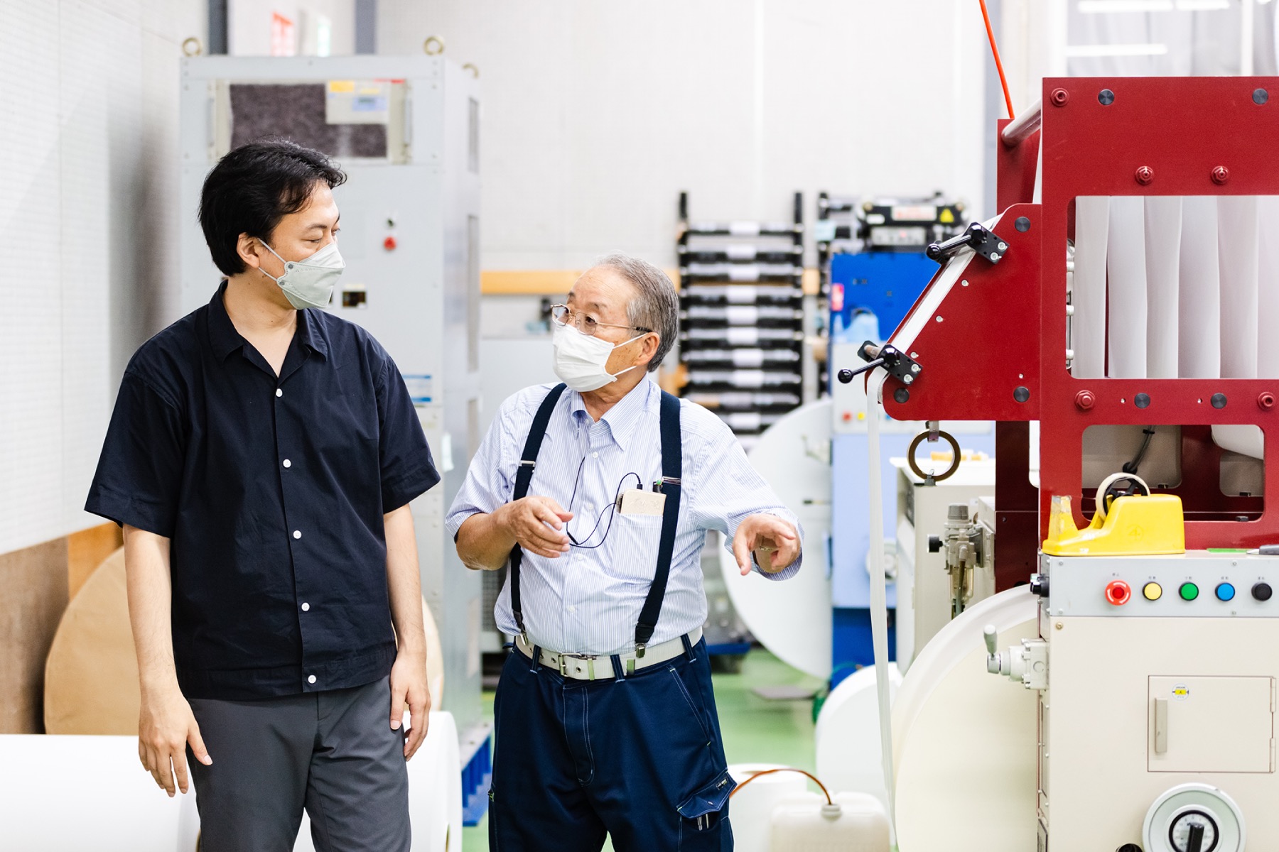 Mr. Yuyama receives an explanation from Mr. Fukuda regarding the printing process.